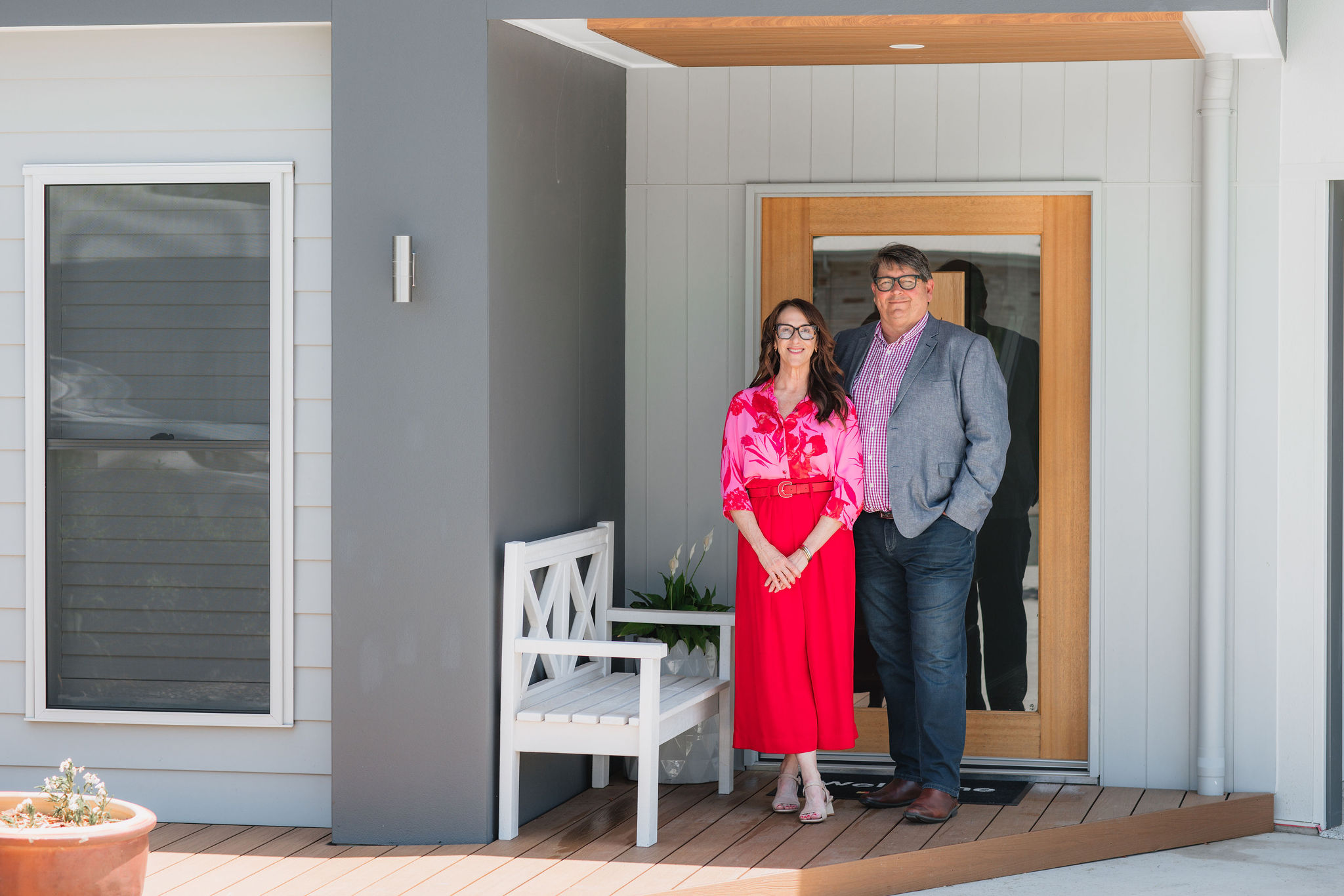 Ron English & Lissa Holgate standing on front porch of beautiful home. 